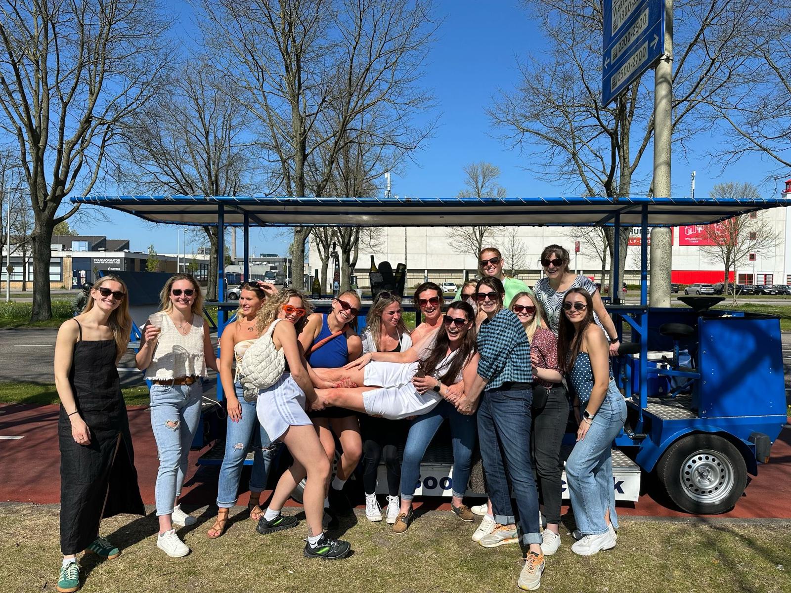 Hen party group lifting friend